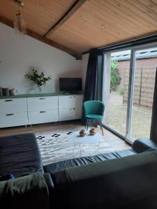 a living room with a couch and a chair at De Spaanse Ruiter in Leusden