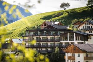 a hotel on top of a green hill at Hotel Alcialc in La Valle
