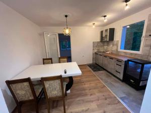 a kitchen with a large white table and chairs at Apartman Kastel in Travnik