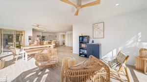 a living room with wicker chairs and a table at Salt n Sand Beach house - 10min walk to Ocean - Idyllic coastal village in Ocean Shores