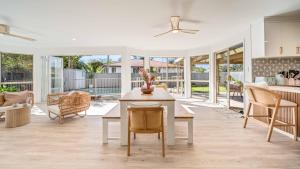 a kitchen and living room with a table and chairs at Salt n Sand Beach house - 10min walk to Ocean - Idyllic coastal village in Ocean Shores