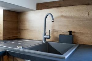 a kitchen sink with a faucet on a counter at Apartments Victoria in Dramalj +55 photos