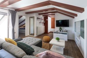 a living room with a couch and a tv at Apartments Victoria in Dramalj
