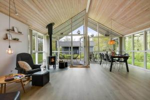 a living room with a fireplace and a table at C11323-Tarm-Brombaervej-8 in Tarm