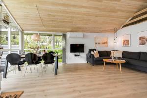 a living room with a couch and a table at C11323-Tarm-Brombaervej-8 in Tarm