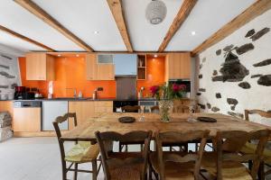 a kitchen with a wooden table and chairs at Chalet Le Hameau Tranquille in Courchevel