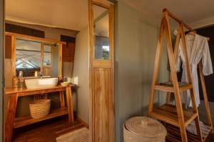 a bathroom with a sink and a mirror at Manya Luxury Camp in Serengeti