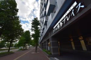 a building with a sign on the side of it at Hotel Hakata Place in Fukuoka