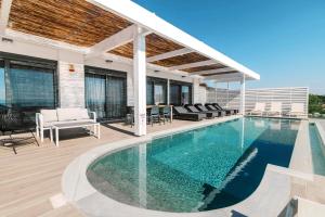 a swimming pool in a house with a patio at Cavo Lindos Villas in Lindos