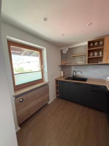 a kitchen with a sink and a window at Chalet Lilly inkl. Chiemgaukarte in Ruhpolding