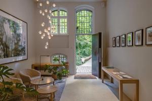 a living room with a table and chairs and a large window at Wilmina Apartments & Lofts in Berlin