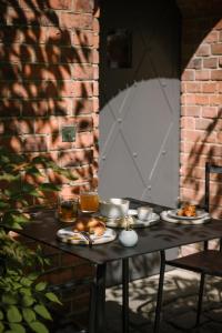 a table with plates of food on top of it at Wilmina Apartments & Lofts in Berlin
