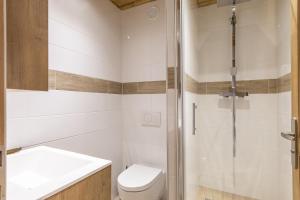 a bathroom with a shower and a toilet and a sink at Résidence La Forêt Du Praz - Courchevel 1850 in Courchevel