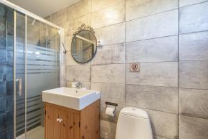 a bathroom with a sink and a toilet and a mirror at Sunwaves 2 - Casa Oasis in El Palmar +16 photos