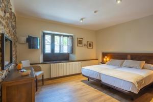 a bedroom with a large bed and a window at La Posada del Vencejo in Alles