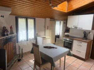 a kitchen with a table and a table and chairs at Casa Helvezia in Cadenazzo