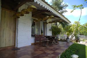 a patio with awning and a table and chairs at White Castle in Malavli