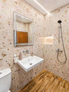 a bathroom with a sink and a toilet and a mirror at Kazlarov Guest House in Kiten +172 photos