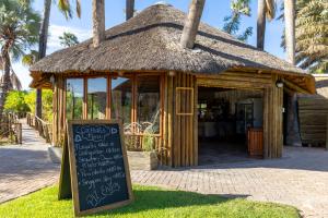a small hut with a sign in front of it at Palmwag Lodge in Palm