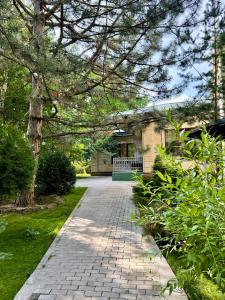a brick walkway leading to a house at Mirali Resort in Almaty