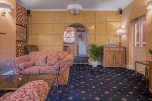a living room with a couch and a chair at Lonsdale House in Bowness-on-Windermere