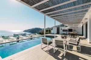 a house with a swimming pool and a patio at Cavo Lindos Villas in Lindos