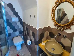 a bathroom with a sink and a toilet and a mirror at Appartamenti Alba&Tramonto in Stromboli