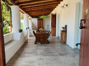 a patio with a table and chairs on a house at Appartamenti Alba&Tramonto in Stromboli