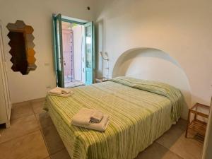 a bedroom with a bed with two towels on it at Appartamenti Alba&Tramonto in Stromboli