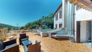 a patio with chairs and a slide on a building at HÔTEL Relais de Monti in Menton