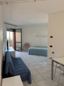 a bedroom with a bed and a desk and a table at La CASA DI ALE in Imola