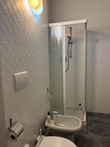 a bathroom with a shower and a toilet and a sink at La CASA DI ALE in Imola +16 photos