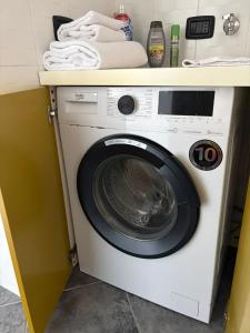 a washing machine under a counter in a kitchen at La CASA DI ALE in Imola