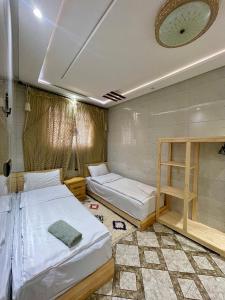 a room with two beds and a ladder in it at Arinas Surf Hostel in Taghazout +73 photos