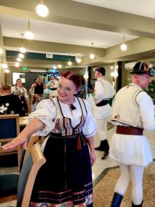 two people in traditional clothing standing in a room at Deny Inn Harmony in Zărneşti +38 photos