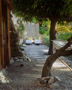 a stone pathway with two benches and a tree at Monastero Retreat - Villa con SPA in Lanzo dʼIntelvi