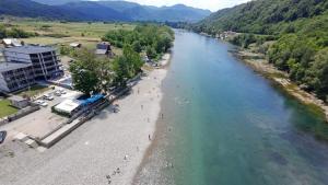 a view of a river with people on the beach at Drinsko Srce Tegare in Bratunac
