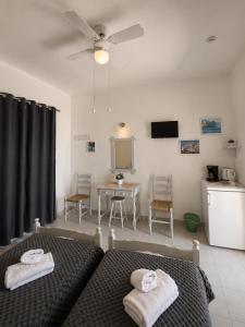 a bedroom with a bed and a table with chairs at Panagiotis Rooms in Naousa