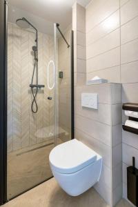 a bathroom with a toilet and a shower at Dutch Design Hotel Vondelpark in Amsterdam