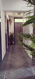 a hallway with plants in front of a door at B&B Adriatico in Giulianova