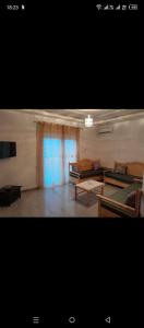a living room with a bed and a couch at Jouini tasyif in Kelibia