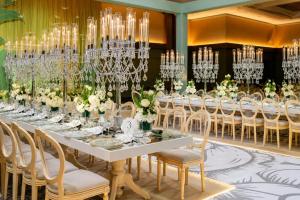 a long banquet table with white chairs and chandeliers at Istanbul Marriott Hotel Sisli in Istanbul +162 photos