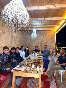 a group of people sitting around a table at Arinas Surf Hostel in Taghazout