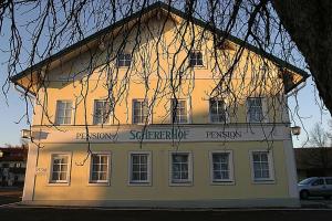 a large white building with a sign on it at Pension Schererhof in Pliening