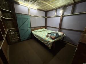 an overhead view of a small room with a bed at The Hojai Farmland in Hāflong