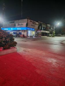 an empty street in front of a store at night at INTOWN Hotel in Islamabad +32 photos