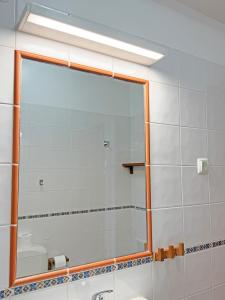 a bathroom with a large mirror and a sink at Casa Formosinha Cabanas Beach in Cabanas de Tavira +21 photos