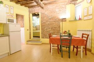 a kitchen and dining room with a table and chairs at CozyBricks in Lucca - Apartments in Lucca Historical Center - Air Cond & WiFi - in Lucca +28 photos