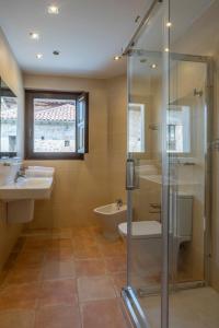 a bathroom with two sinks and a shower and a toilet at La Posada del Vencejo in Alles +34 photos