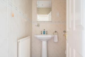 a bathroom with a sink and a mirror at Lonsdale House in Bowness-on-Windermere +55 photos